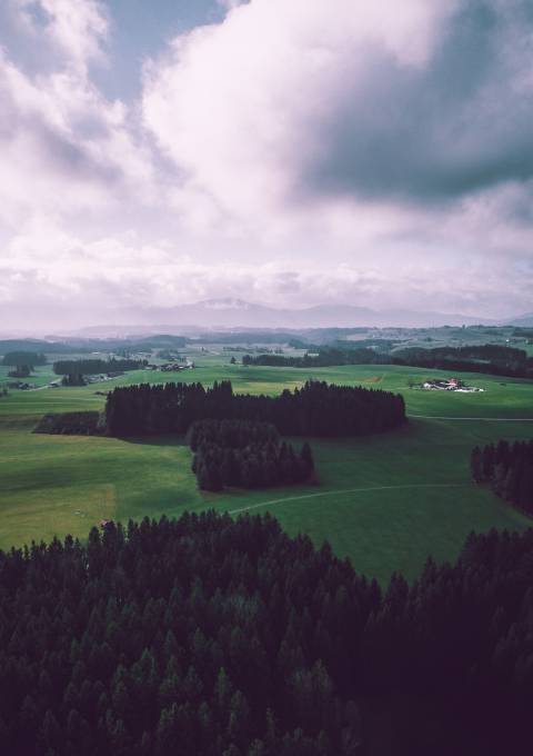 Weitläufiger Feng-Shui-Golfplatz mit Bergen und grünen Wiesen im Hintergrund