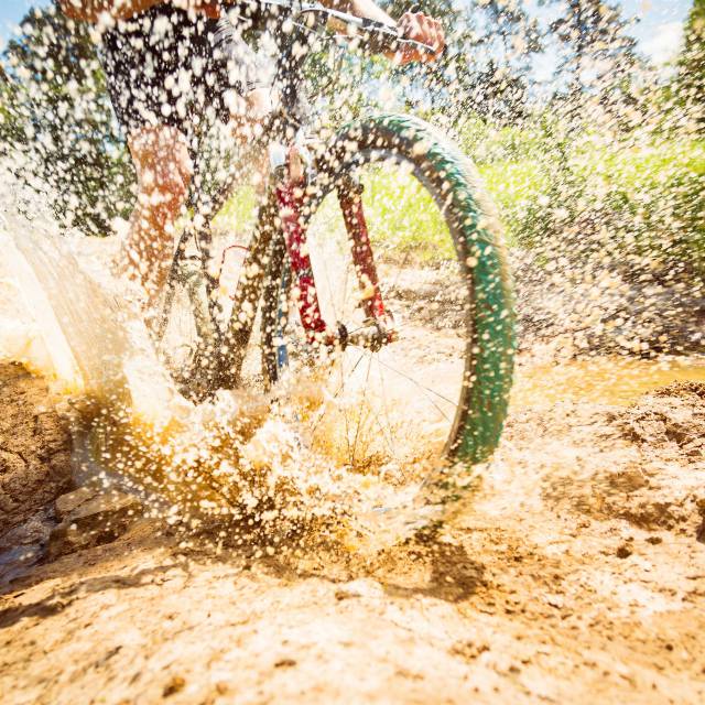 Mountainbike fährt durch Schlammpfütze